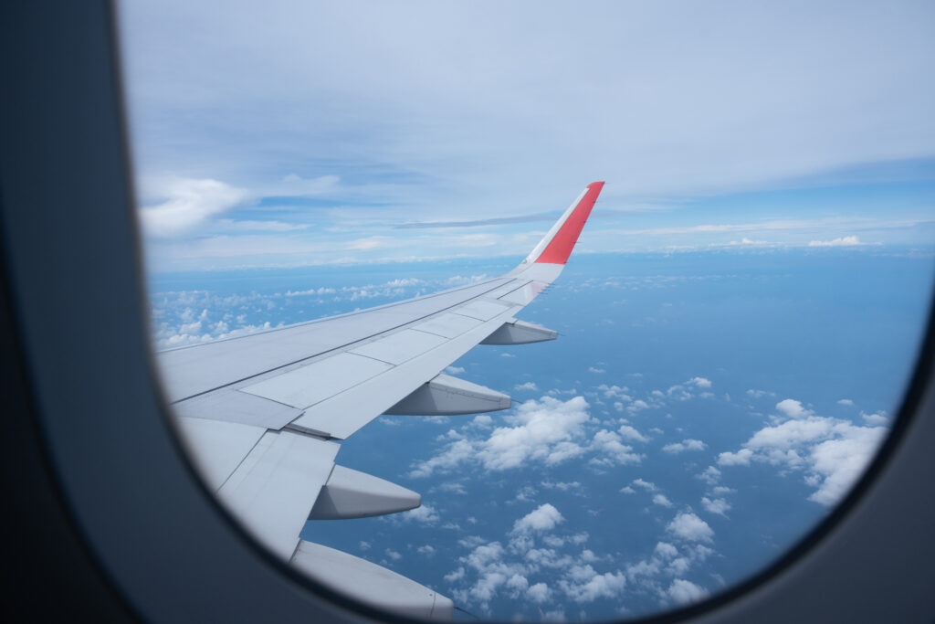 airplane wing flying above the sky with white clou 2023 03 24 21 27 54 utc 1024x683