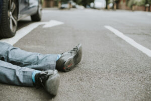 person lying on the ground after a car accident 2022 12 16 01 00 20 utc scaled