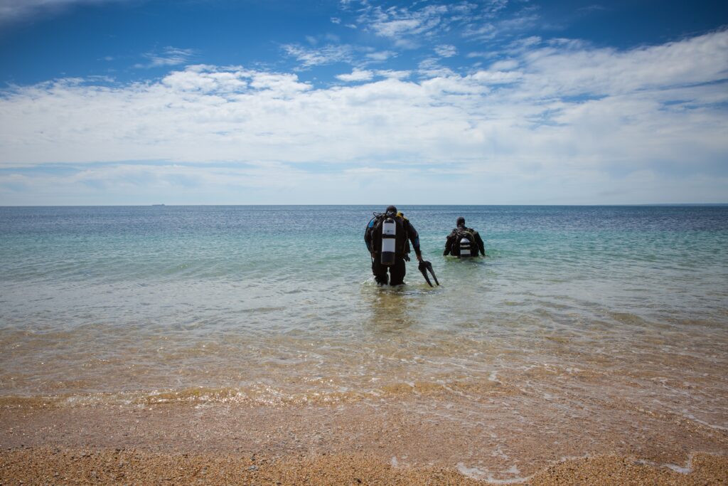 two deep sea divers wearing oxygen tanks and wetsu 2022 11 11 06 59 09 utc 1024x683