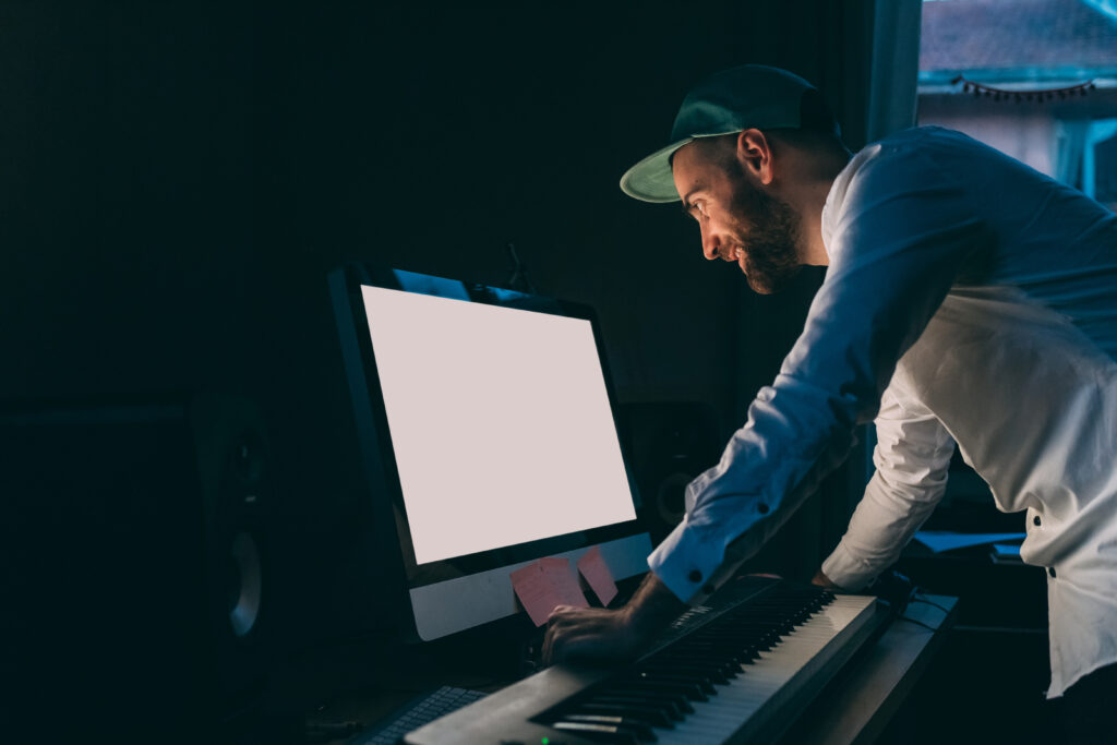 young man indoor using computer and pianola 2022 01 28 21 50 47 utc 1024x683