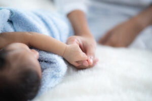 parent hands holding newborn baby fingers close u 2022 12 16 02 55 41 utc scaled