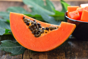 papaya slice on wood 2021 09 03 19 08 28 utc scaled