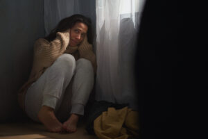 scared woman sitting on ground and covering her he 2023 11 27 05 11 44 utc scaled