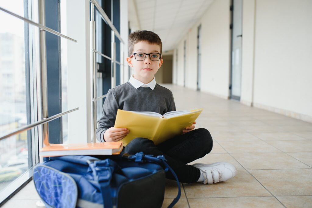 schoolboy sits on the floor of a school hallway an 2023 12 01 00 09 09 utc scaled