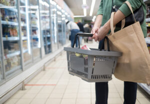 woman with a shopping basket at a grocery store 2023 11 27 05 07 08 utc scaled