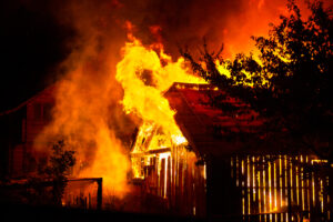 wooden house or barn burning on fire at night 2023 11 27 05 33 02 utc scaled