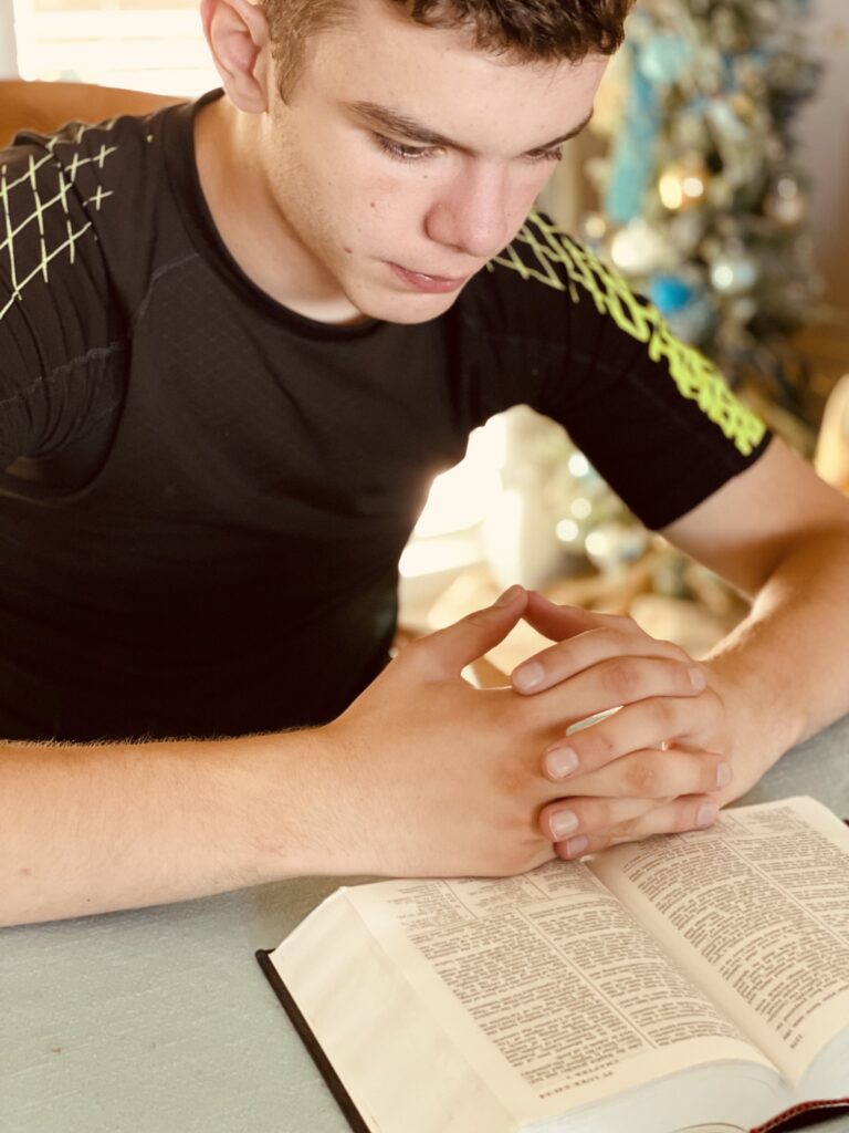 teenage boy hands folded reading bible bible st 2023 11 27 05 11 04 utc scaled