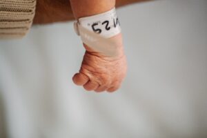 newborn baby hand with a hospital tag 2023 11 27 05 05 23 utc scaled