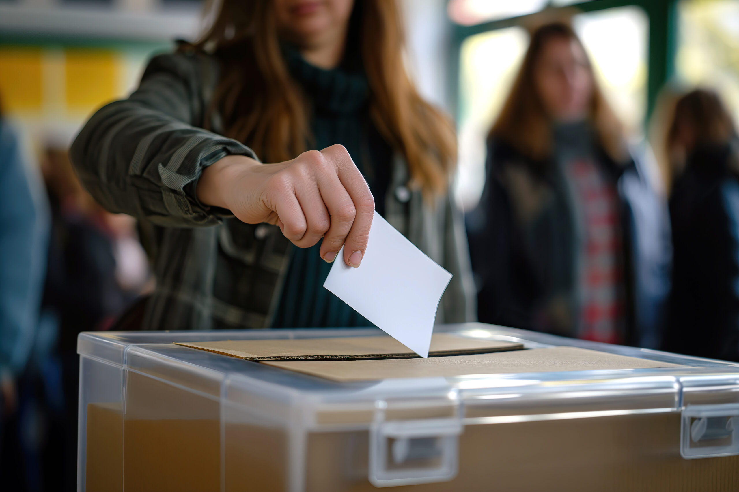 person depositing voting card into ballot box for 2024 01 09 18 45 57 utc scaled