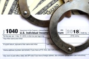 police handcuffs lie on the tax form 1040 2023 11 27 05 00 21 utc scaled