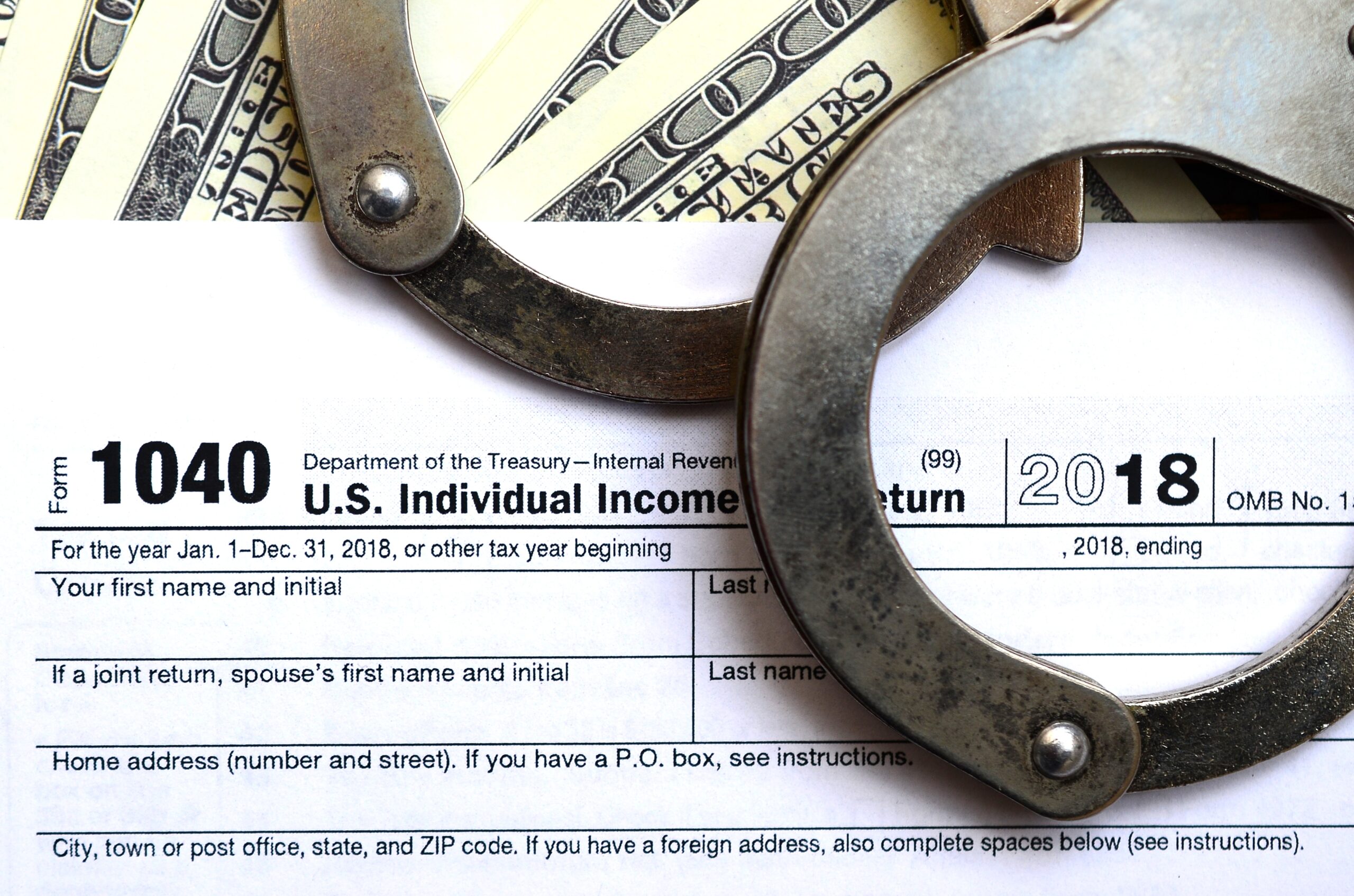 police handcuffs lie on the tax form 1040 2023 11 27 05 00 21 utc scaled