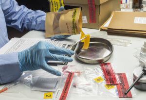 police scientist holding rubber band evidence bag 2023 11 27 05 32 41 utc scaled