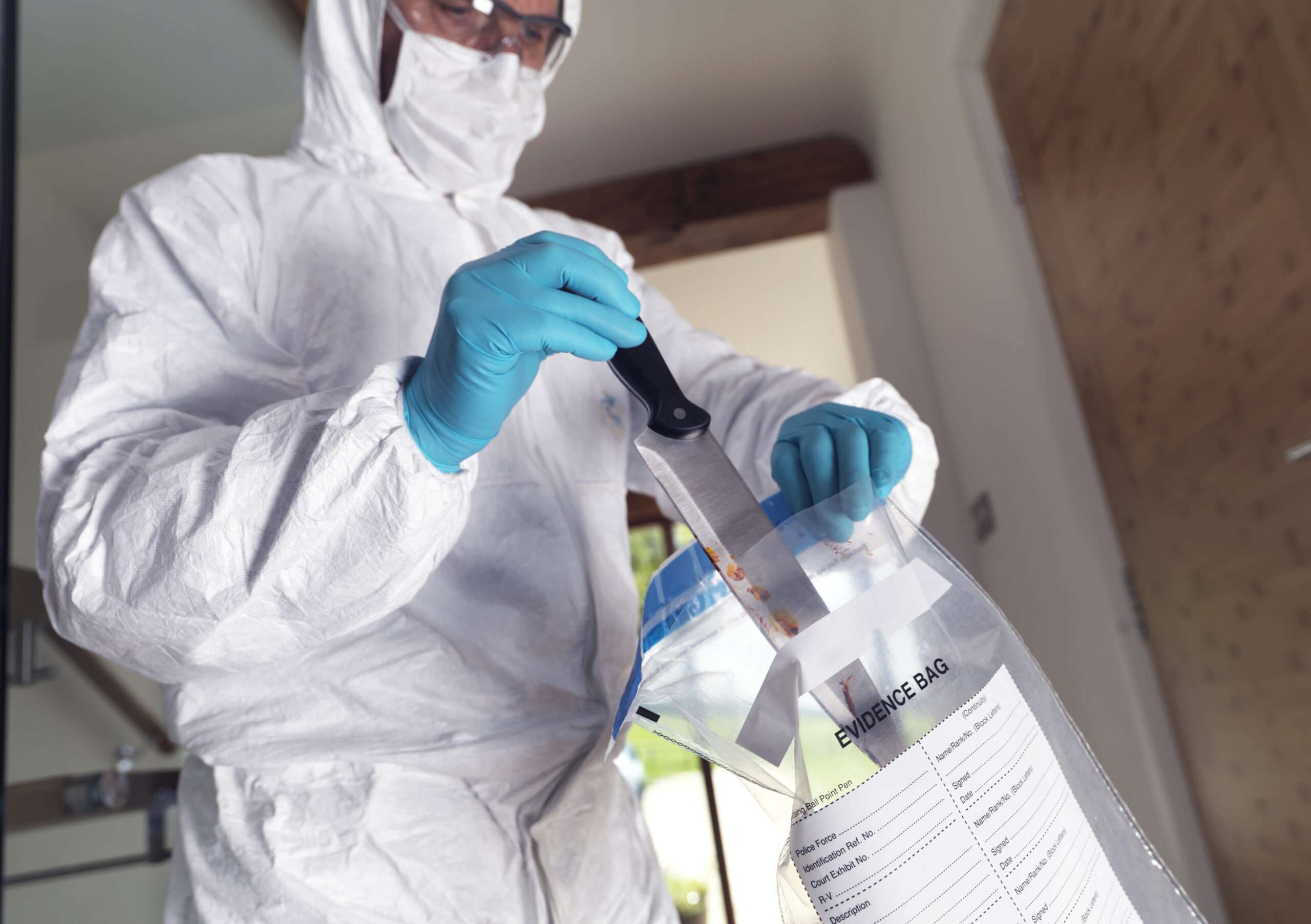 Forensic scientist bagging a knife taken from a violent crime scene